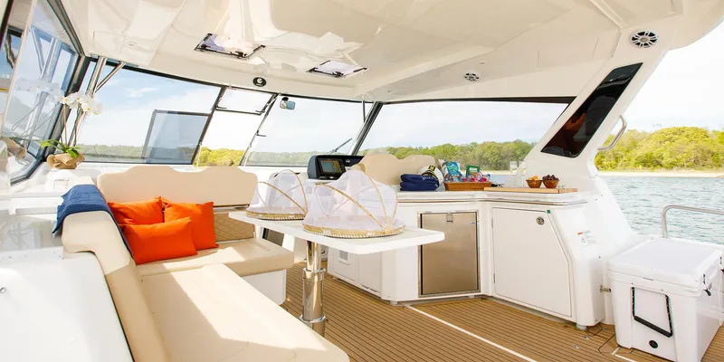 Slide: The Image of Luxurious interior of 2021 Aquila 36 Sport yacht with seating and kitchenette. - 19