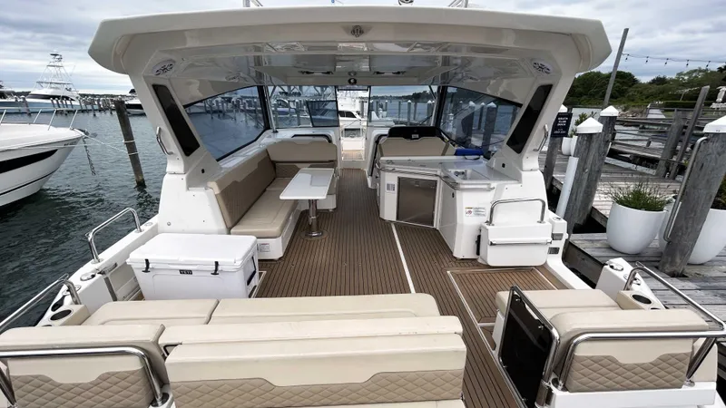 Slide: The Image of 2021 Aquila 36 Sport yacht interior with seating and table, docked at marina. - 6