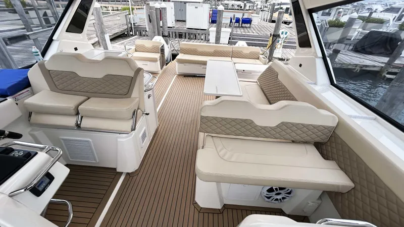 Slide: The Image of Interior of 2021 Aquila 36 Sport boat with beige seating and wood flooring. - 7