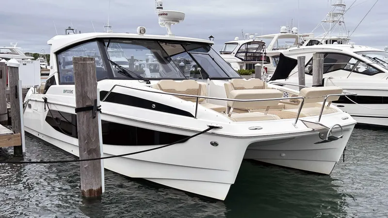 Slide: The Image of Aquila 36 Sport 2021 boat docked at marina, featuring sleek design and spacious seating. - 2