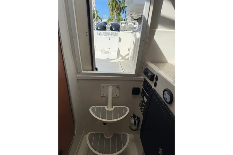Slide: The Image of Interior view of 2014 Sailfish 270 WAC boat, featuring cabin steps and control panel. - 14