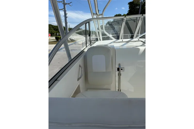 Slide: The Image of 2014 Sailfish 270 WAC boat interior with seating and clear windshield view. - 17