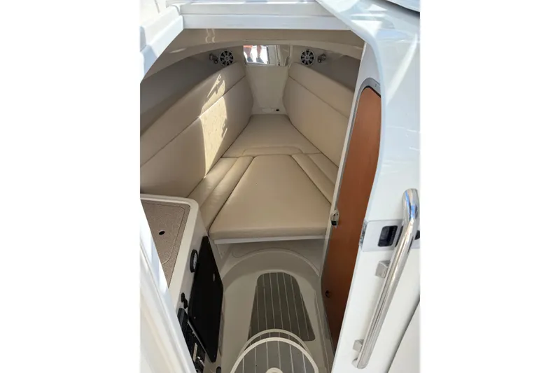 Slide: The Image of 2014 Sailfish 270 WAC cabin interior with beige seating and modern design. - 18