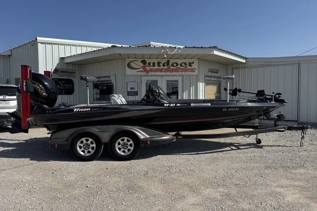 The Image of 2006 Triton 21 TrX boat on trailer outside Outdoor Specialties store. - 1