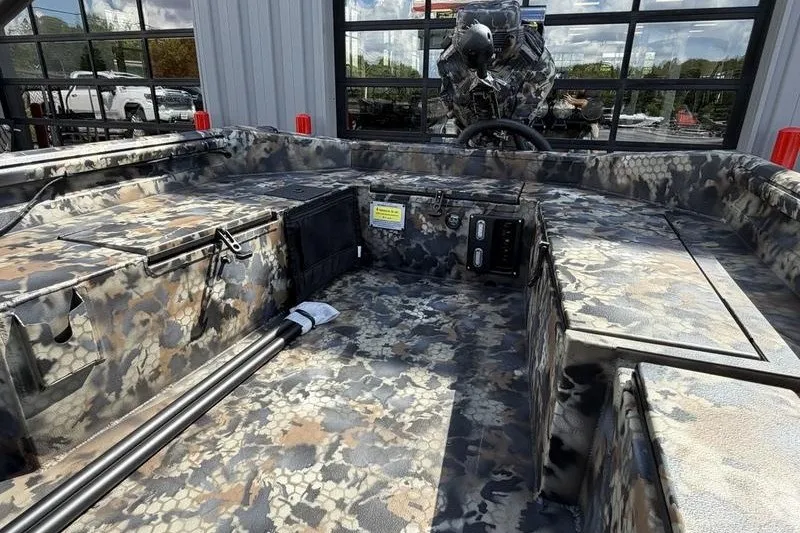 Slide: The Image of 2027 Excel 1754 Shallow Water F4 boat interior with camouflage design, outdoor setting. - 14