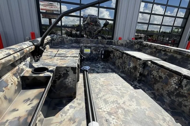 Slide: The Image of 2027 Excel 1754 Shallow Water F4 boat with camouflage interior, parked outdoors. - 1