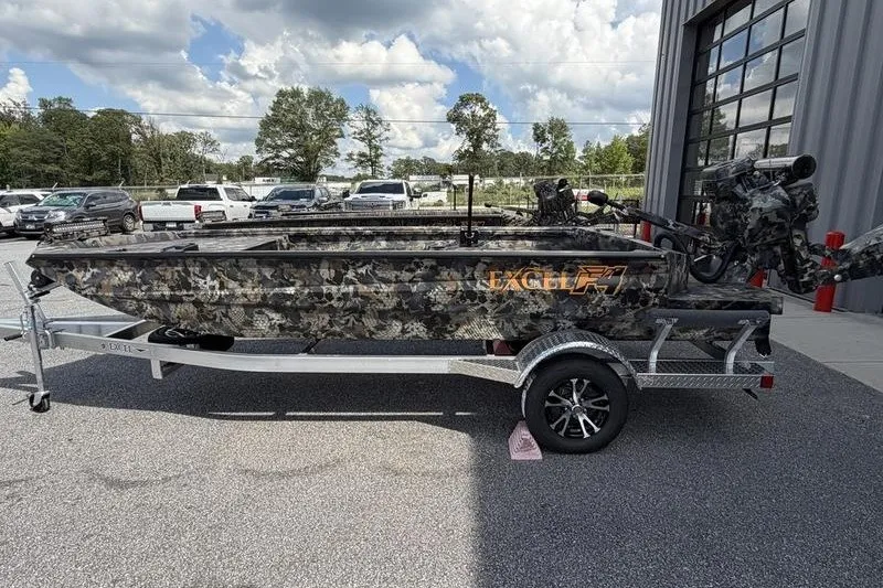 Slide: The Image of 2027 Excel 1754 Shallow Water F4 boat on trailer, camo design, parked outdoors. - 21