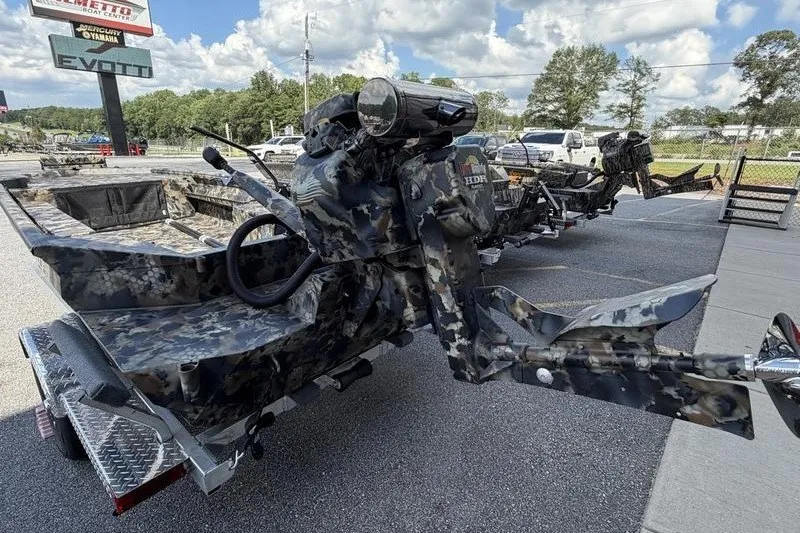 Slide: The Image of 2027 Excel 1754 Shallow Water F4 boat with camouflage design on a trailer. - 15