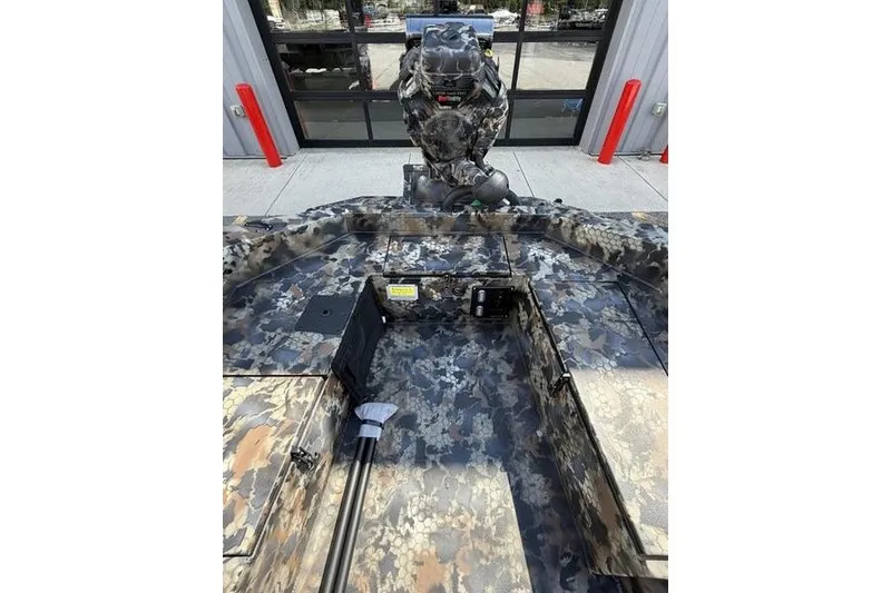 Slide: The Image of 2027 Excel 1754 Shallow Water F4 boat with camouflage design, displayed outdoors. - 5