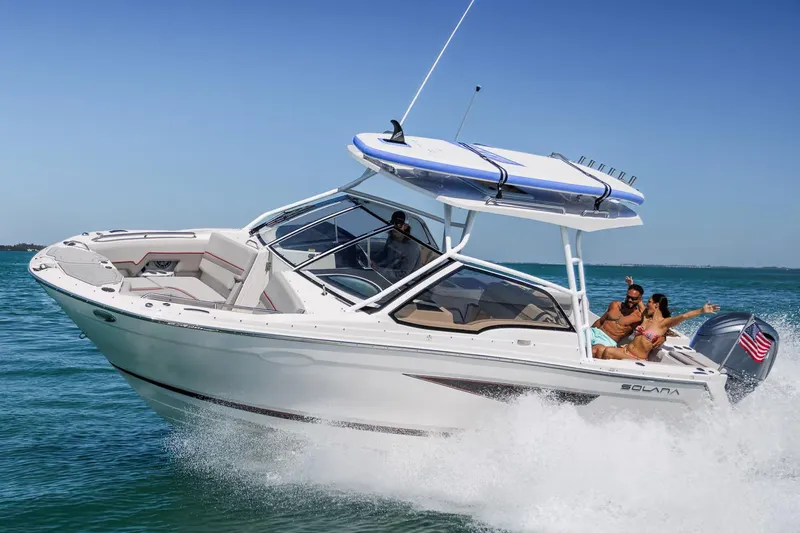 Slide: The Image of Manufacturer Provided Image: 2026 Solara S-250 DC boat cruising on clear blue water with passengers enjoying the ride. - 0