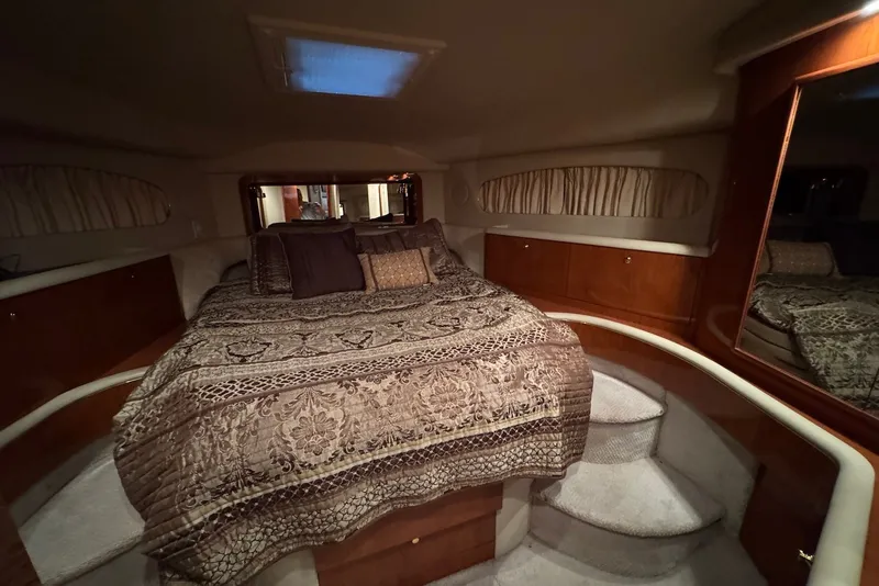Slide: The Image of Luxurious bedroom interior of 1998 Sea Ray 420 Aft Cabin yacht with elegant bedding. - 19