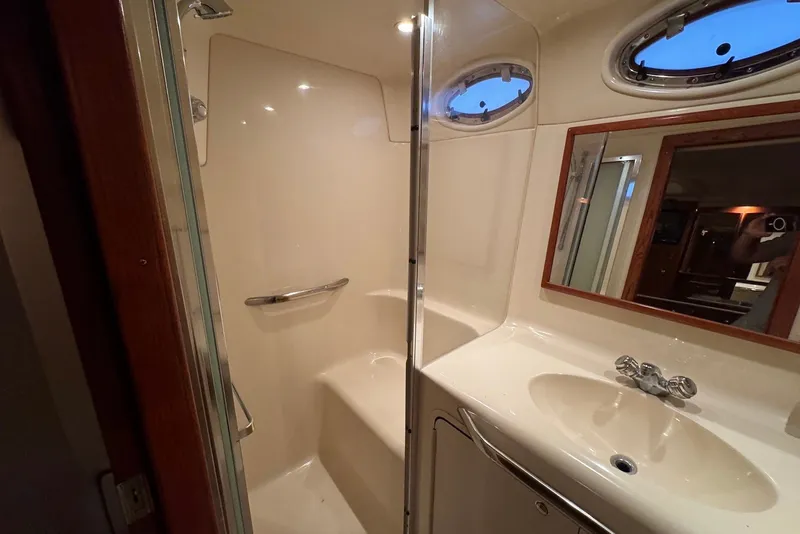Slide: The Image of Bathroom interior of 1998 Sea Ray 420 Aft Cabin yacht, featuring shower and sink. - 23