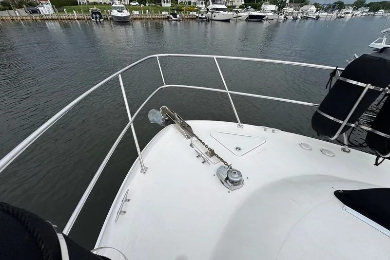 Slide: The Image of Bow view of 1998 Sea Ray 420 Aft Cabin yacht docked in a marina. - 11
