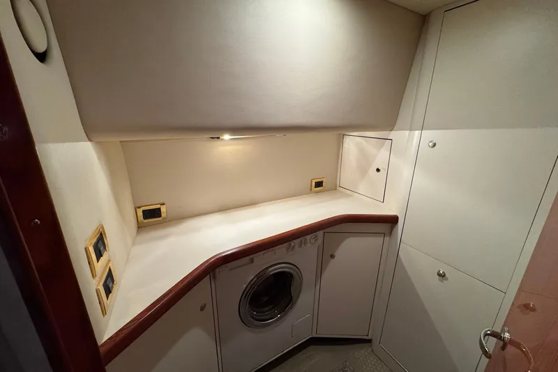 Slide: The Image of Laundry area in 1998 Sea Ray 420 Aft Cabin yacht with washer and storage cabinets. - 17