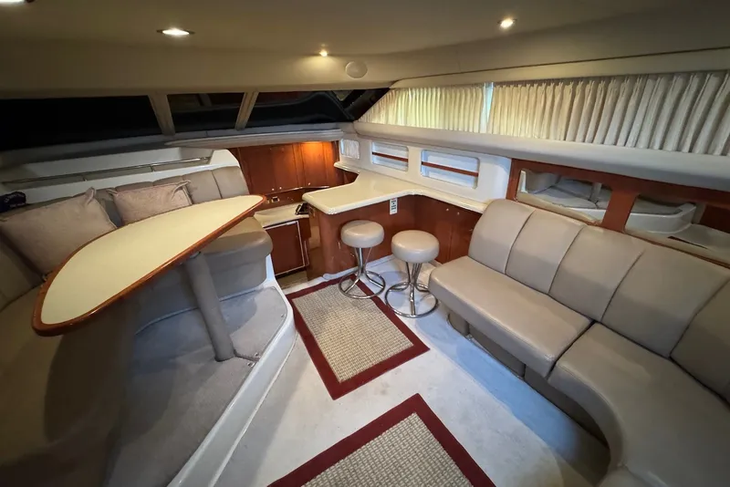 Slide: The Image of Luxurious interior of 1998 Sea Ray 420 Aft Cabin yacht with seating and dining area. - 13