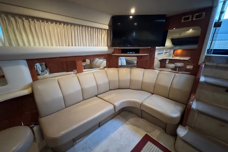 Slide: The Image of Luxurious interior of 1998 Sea Ray 420 Aft Cabin yacht with curved leather seating. - 15