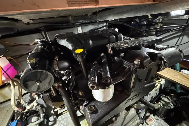 Slide: The Image of Engine compartment of a 1998 Sea Ray 420 Aft Cabin boat, showcasing mechanical components. - 26