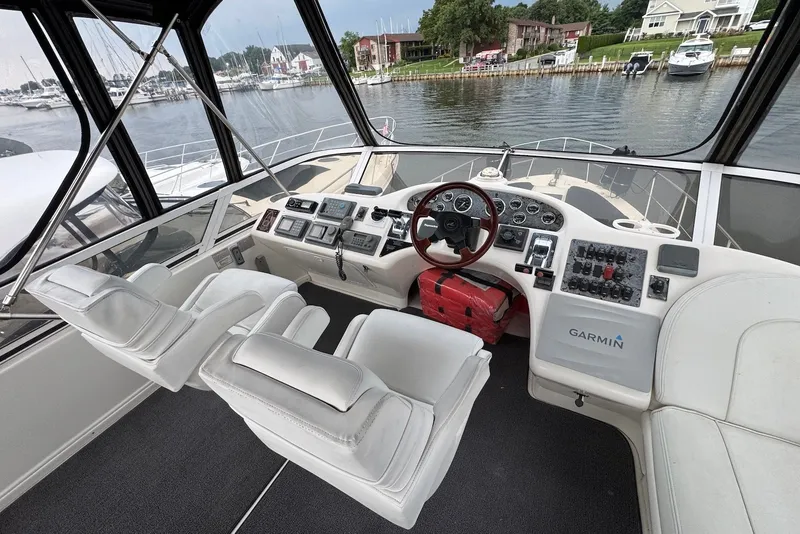 Slide: The Image of 1998 Sea Ray 420 Aft Cabin helm with Garmin navigation, overlooking marina. - 6