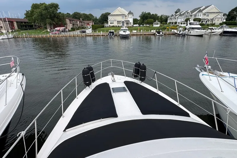 Slide: The Image of Bow view of 1998 Sea Ray 420 Aft Cabin yacht docked in a marina. - 9