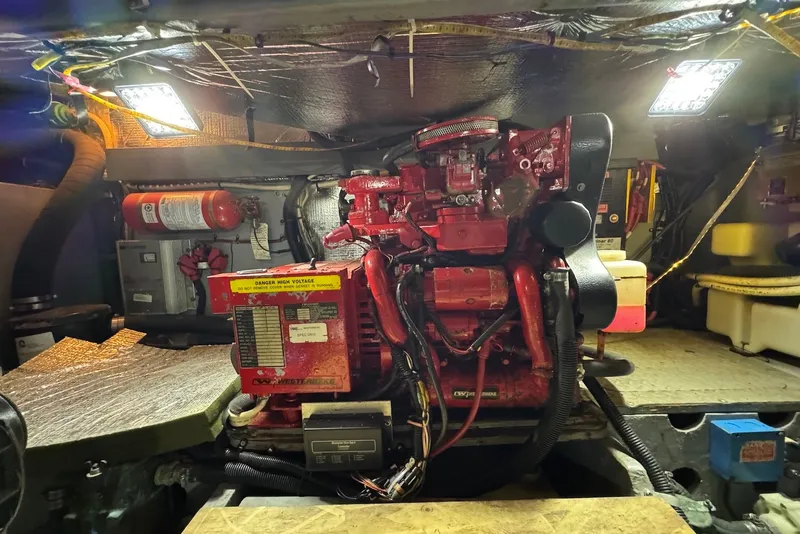 Slide: The Image of Engine room of a 1998 Sea Ray 420 Aft Cabin with visible machinery and equipment. - 24