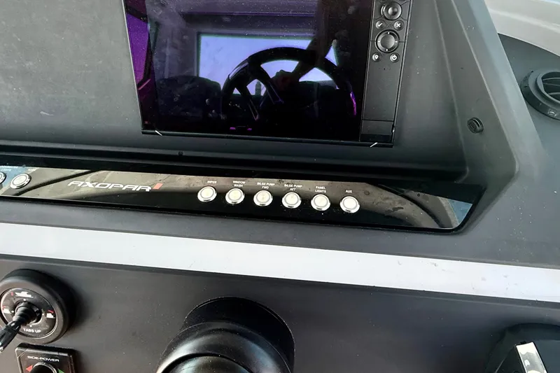 Slide: The Image of Control panel of 2022 Axopar 28 Cabin boat with navigation screen and buttons. - 22