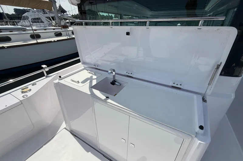 Slide: The Image of 2022 Axopar 28 Cabin boat with open deck sink and storage area. - 14