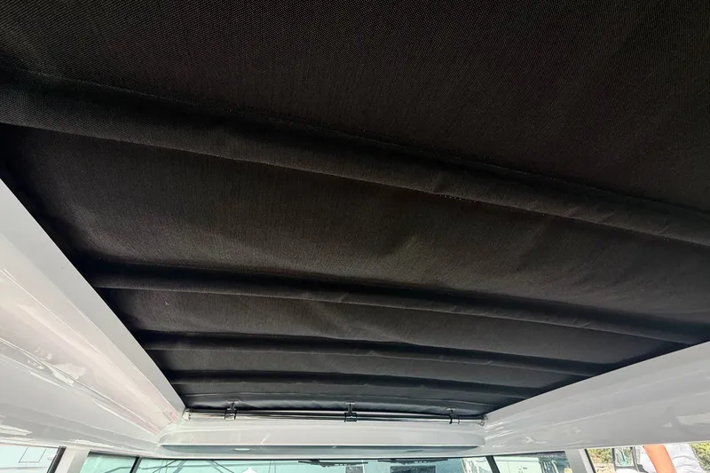 Slide: The Image of Roof interior of 2022 Axopar 28 Cabin boat, featuring sleek black fabric design. - 26