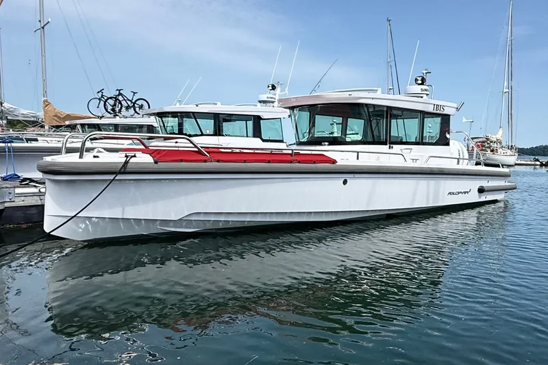 Slide: The Image of 2022 Axopar 28 Cabin boat docked in marina, featuring sleek design and modern amenities. - 1