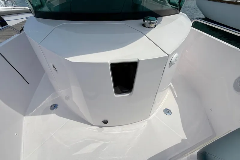Slide: The Image of 2022 Axopar 28 Cabin boat deck with sleek white design and modern features. - 33