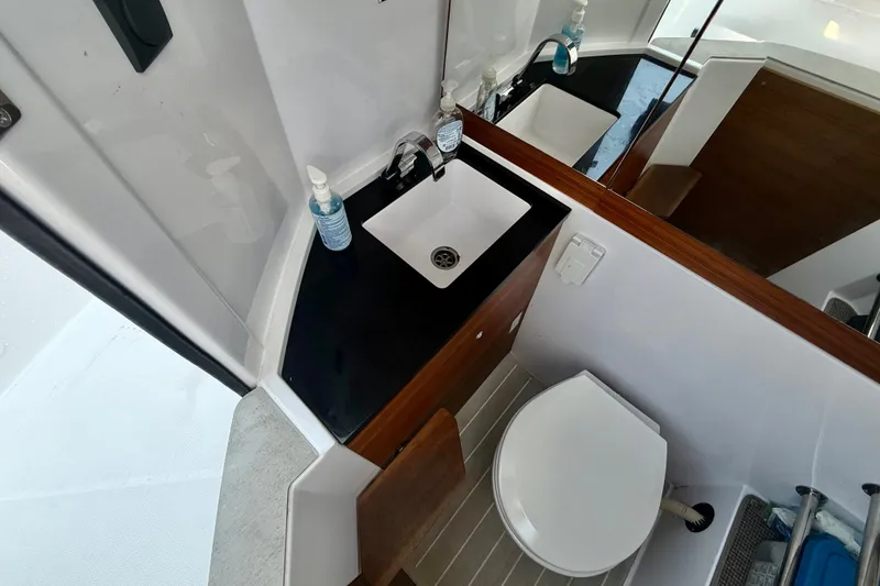 Slide: The Image of Modern bathroom in 2022 Axopar 28 Cabin boat with sink and toilet. - 36