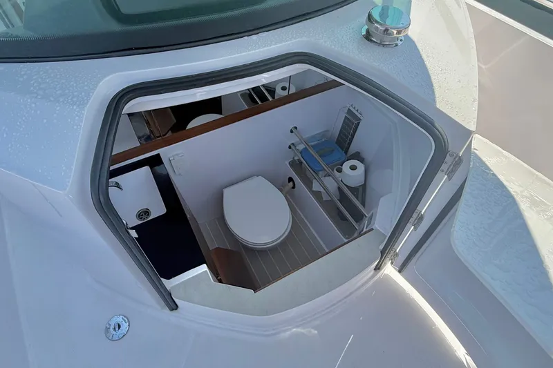 Slide: The Image of 2022 Axopar 28 Cabin boat interior with compact bathroom amenities. - 34