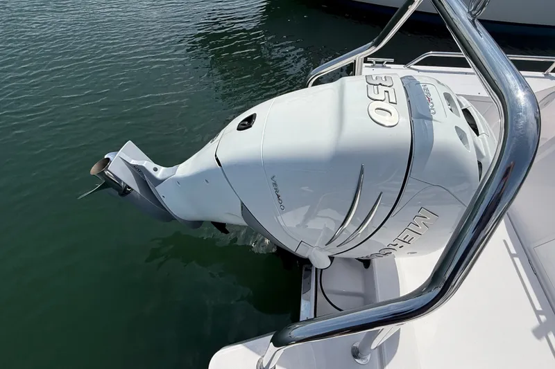 Slide: The Image of Outboard motor on 2022 Axopar 28 Cabin boat, docked on calm water. - 7