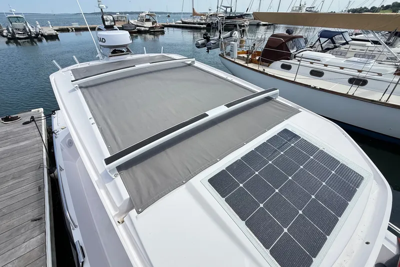Slide: The Image of 2022 Axopar 28 Cabin boat with solar panel, docked at marina. - 37