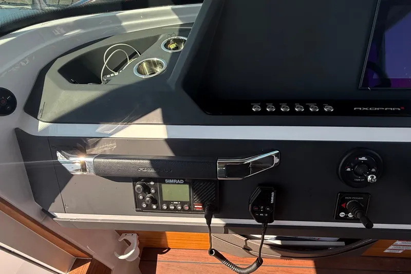 Slide: The Image of Control panel of 2022 Axopar 28 Cabin boat with Simrad electronics and modern dashboard. - 21