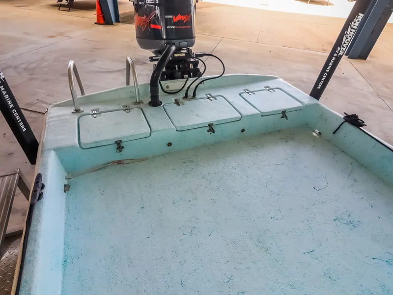 Slide: The Image of A boat with an outboard motor and several storage compartments on the deck. - 20