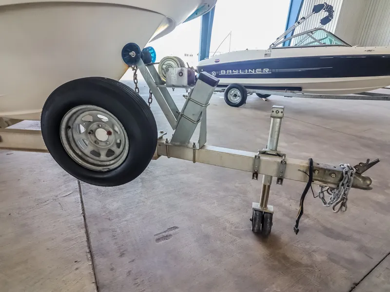 Slide: The Image of A boat trailer with a wheel and hitch in a storage facility. - 25