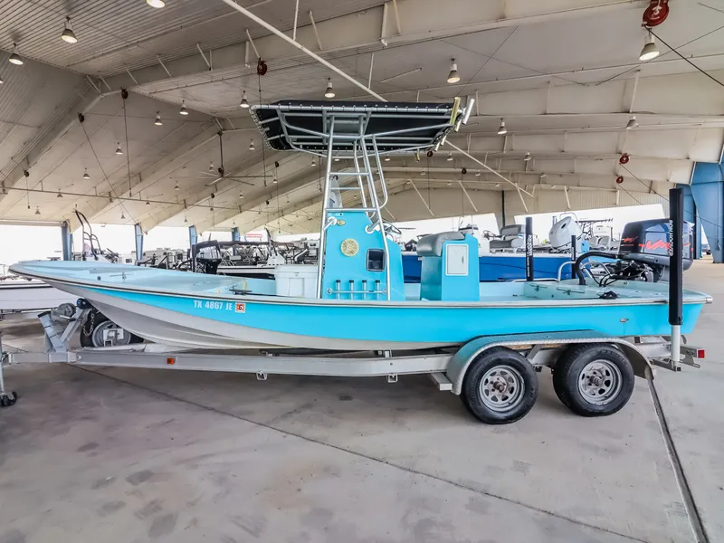 Slide: The Image of A blue fishing boat on a trailer in a covered storage facility. - 4