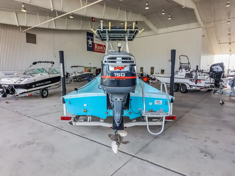 Slide: The Image of A blue boat with a 150 HP outboard motor in a large indoor space. - 7