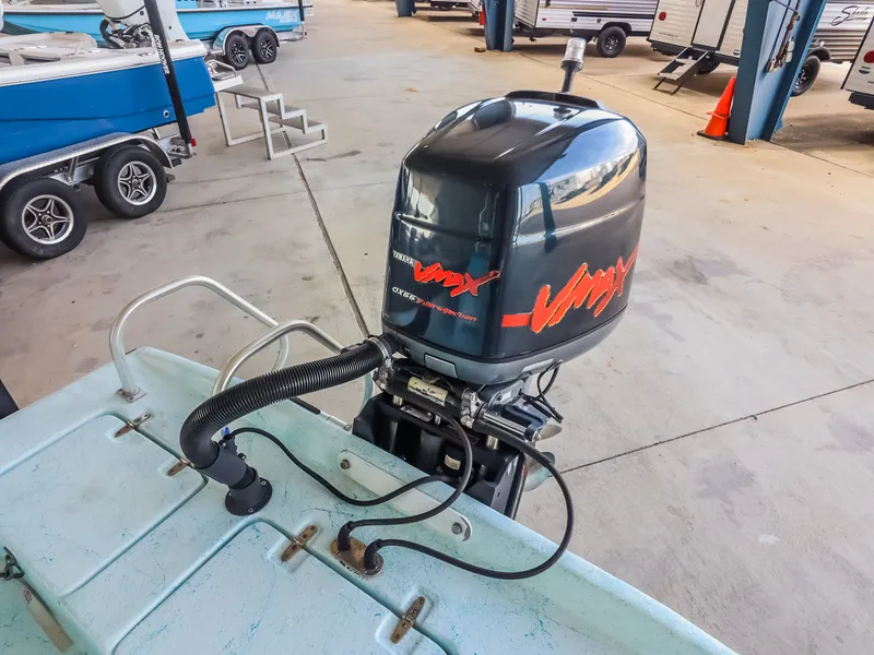 Slide: The Image of An outboard motor with VMAX logo on a boat, surrounded by other boats in a storage facility. - 22