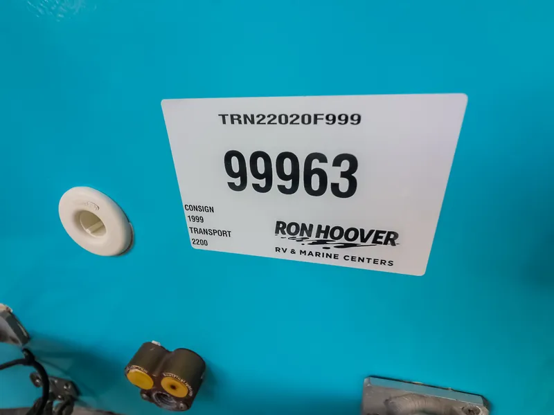 Slide: The Image of A blue boat with a Ron Hoover RV & Marine Centers sticker. - 9