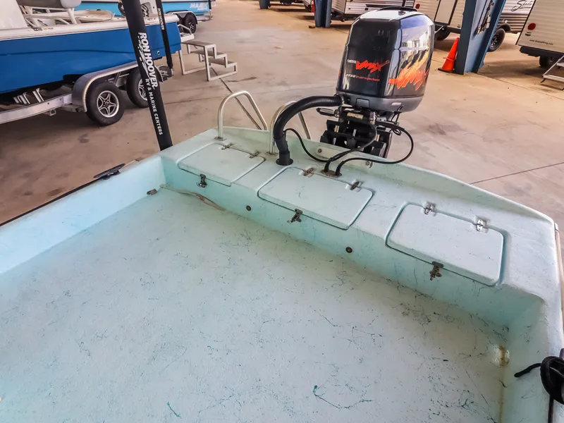 Slide: The Image of An open boat with an outboard motor and several storage compartments on the deck. - 21