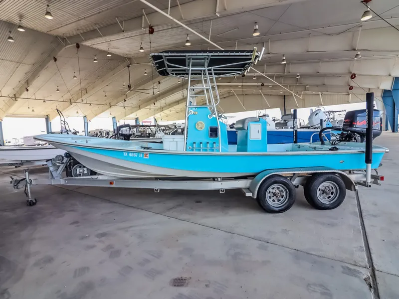 Slide: The Image of A blue fishing boat on a trailer in a covered storage facility. - 2