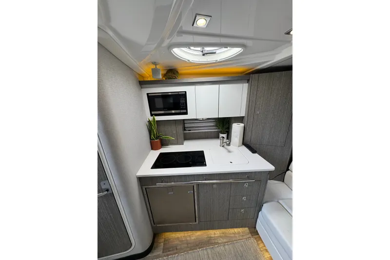 Slide: The Image of Modern kitchen interior of 2021 Monterey 335 Sport Yacht with sleek cabinetry and appliances. - 26