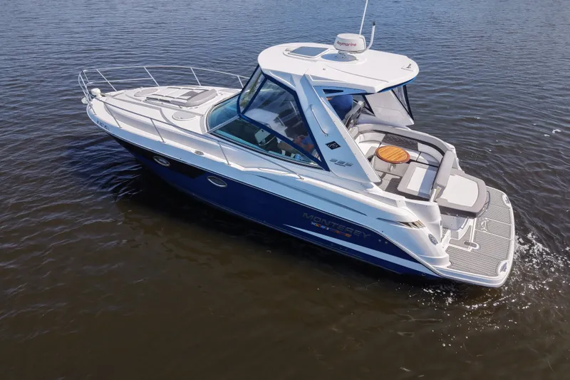 Slide: The Image of 2021 Monterey 335 Sport Yacht cruising on calm waters, showcasing sleek design and luxury features. - 11