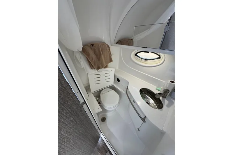 Slide: The Image of Bathroom interior of 2021 Monterey 335 Sport Yacht, featuring modern fixtures and porthole window. - 42