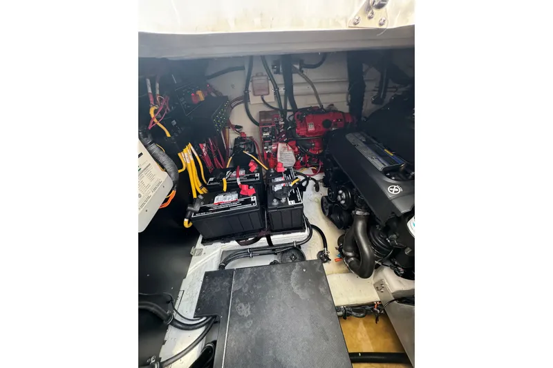 Slide: The Image of Engine compartment of a 2021 Monterey 335 Sport Yacht with visible batteries and wiring. - 64
