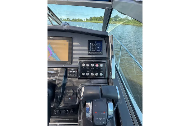 Slide: The Image of Cockpit view of 2021 Monterey 335 Sport Yacht with navigation controls and waterway. - 46