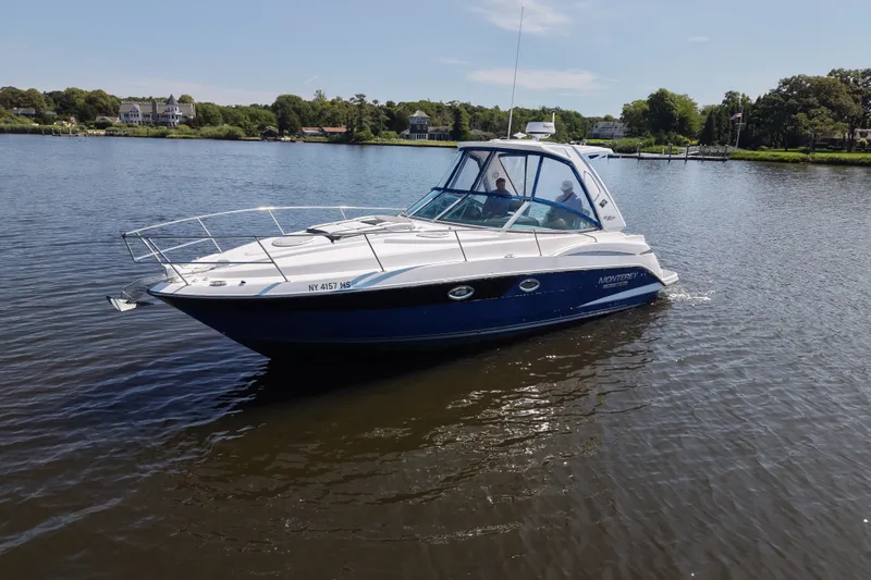 Slide: The Image of 2021 Monterey 335 Sport Yacht cruising on a calm lake under a clear sky. - 4