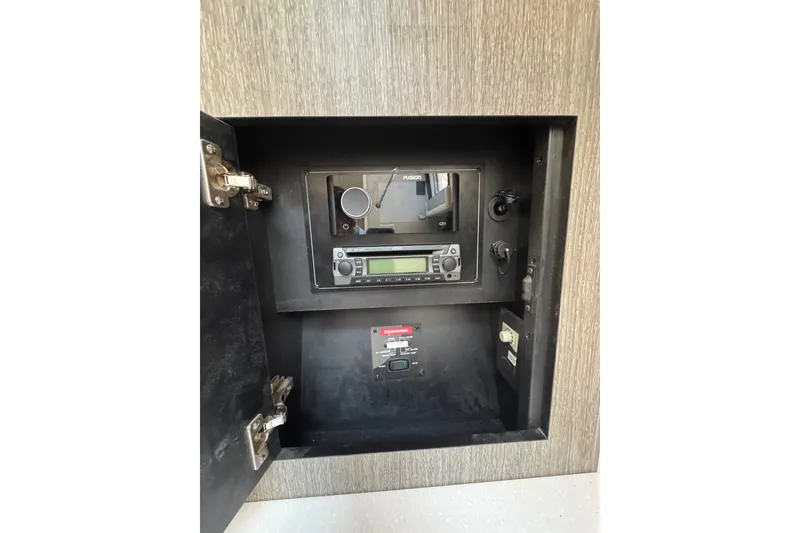 Slide: The Image of 2021 Monterey 335 Sport Yacht control panel with audio system and switches. - 44