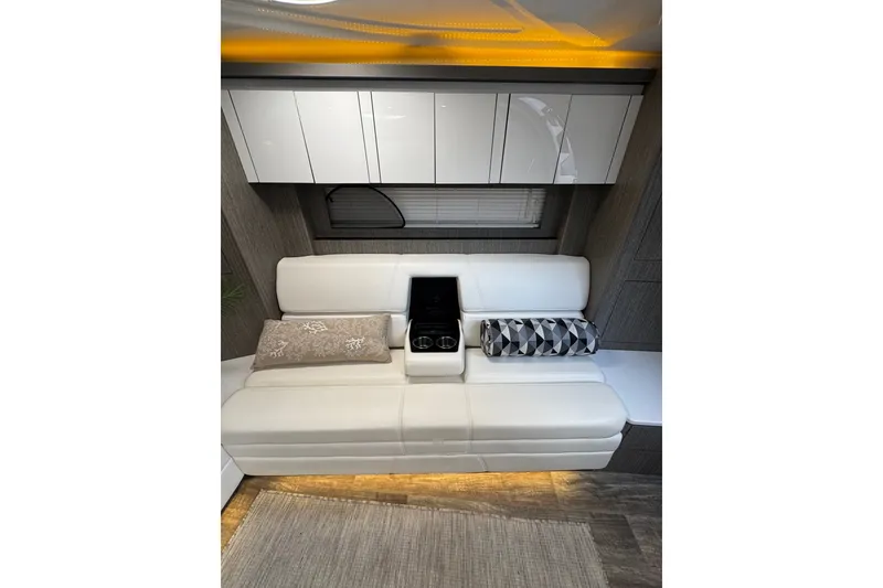 Slide: The Image of Interior of 2021 Monterey 335 Sport Yacht with modern white seating and ambient lighting. - 31
